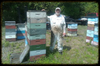 Gary Stockins Posing with a Stack of Bee Hives