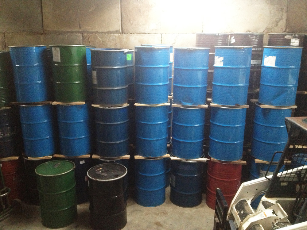 Stacks of large blue drums containing honey